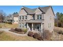 Two story brick home with a front porch and walkway at 6361 Willow Farm Dr, Denver, NC 28037