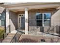 Brick front porch with seating and a gray front door at 6361 Willow Farm Dr, Denver, NC 28037