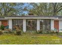 Rear view of the house showing a bright sunroom addition featuring three sliding glass doors at 725 Plantation Rd, Lancaster, SC 29720