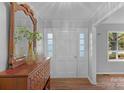 Bright foyer with wood floors, white trim, and decorative dresser with large mirror at 725 Plantation Rd, Lancaster, SC 29720