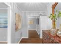 Hallway featuring hardwood floors, modern decor, and open access to multiple rooms at 725 Plantation Rd, Lancaster, SC 29720