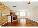 Open living room with hardwood floors, a fireplace, and kitchen access at 733 Jones Branch Rd, Fort Mill, SC 29715