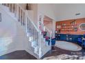 Welcoming foyer with hardwood floors, a staircase with iron railings, and custom paint at 7505 Torphin Ct, Charlotte, NC 28269