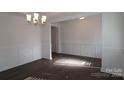 Bright dining room with hardwood floors and wainscoting at 8224 Annsborough Nw Dr, Concord, NC 28027