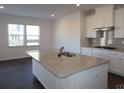 Modern kitchen featuring a large island and granite countertops at 8224 Annsborough Nw Dr, Concord, NC 28027