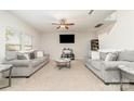 Spacious living room with plush sofas, a ceiling fan, and a mounted television for entertainment at 8411 Washoe Pine Ln, Charlotte, NC 28215