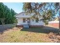 Inviting single-story home with a cozy front porch, grassy lawn, and mature trees providing ample shade at 105 W 21St St, Kannapolis, NC 28081