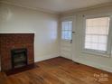 Living room with hardwood floors, fireplace and door at 105 W 21St St, Kannapolis, NC 28081