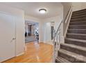 Bright entryway featuring hardwood floors, staircase, and access to multiple living spaces at 11143 Coachman Cir, Charlotte, NC 28277