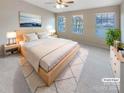 Virtually staged main bedroom with light wood platform bed and large windows at 118 Cadbury Ln, Fort Mill, SC 29715