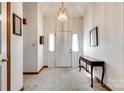 Bright foyer with a white double door entry, neutral carpet, and classic decor at 12104 Baywoods Dr, Tega Cay, SC 29708