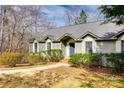 Inviting single-story home with well-maintained landscaping, a blue front door, and a concrete walkway at 12104 Baywoods Dr, Tega Cay, SC 29708