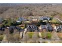 Expansive aerial view of the neighborhood highlighting lush trees and well-spaced homes at 1604 Windy Ridge Rd, Charlotte, NC 28270