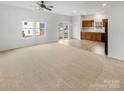 Open living room and kitchen area with neutral carpeting at 1633 Barroso Ln, Charlotte, NC 28213