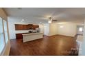 Open-concept living space with dark wood floors, stainless steel appliances, and plenty of natural light at 164 N Cromwell Dr, Mooresville, NC 28115
