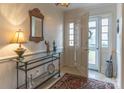 Bright entryway with glass-top console table and patterned rug at 2541 Pinewood Rd, Gastonia, NC 28054