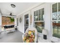 Comfortable front porch featuring white wicker furniture, plants, and welcoming decor at 27 Dove Sw Ave, Concord, NC 28025