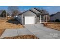 Low angle view of a single Gathering home featuring a one car garage and concrete driveway at 2832 12Th Sw Ave, Hickory, NC 28602