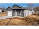 Charming gray single Gathering home featuring a one car garage, concrete driveway and covered porch at 2832 12Th Sw Ave, Hickory, NC 28602