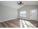 Sunlit living room featuring wood flooring, a ceiling fan, and white trim at 2832 12Th Sw Ave, Hickory, NC 28602