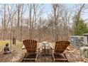 Relaxing backyard seating area with mature trees for privacy and an air conditioning unit at 3028 Summerfield Ridge Ln, Matthews, NC 28105