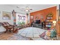 Inviting living room featuring bright natural light, cozy furniture, and decorative plants at 3028 Summerfield Ridge Ln, Matthews, NC 28105