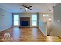 Living room with fireplace, hardwood floors, and neutral walls at 3029 Winding Trl, Matthews, NC 28105