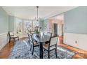 Elegant dining room with a bay window, refined wainscoting, and a stylish chandelier at 3421 Walston Ln, Charlotte, NC 28211