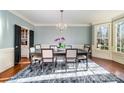 Formal dining room featuring hardwood floors, large windows, and a classic chandelier at 3421 Walston Ln, Charlotte, NC 28211