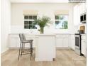 Modern white kitchen with island, stainless steel appliances, and white cabinets at 4076 Skyboat Cir, Fort Mill, SC 29715