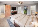 Virtually staged main bedroom with barn door and walk-in closet at 4127 Bon Rea Dr, Charlotte, NC 28226