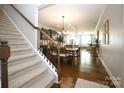 View down carpeted stairs showcasing an open floor plan at 5063 Gribble Ln, Lancaster, SC 29720