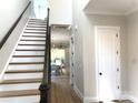 Bright entryway featuring hardwood floors, staircase, and view into the dining area at 553 W Lowrance Ave, Mooresville, NC 28115