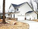 Two-story house with gray siding, brick base, and a two-car garage; side view at 553 W Lowrance Ave, Mooresville, NC 28115