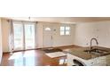 Living room with hardwood floors and access to a back deck at 704 W Border St, Dallas, NC 28034