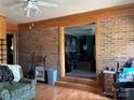 Spacious living room featuring hardwood floors and brick walls, creating a warm and inviting atmosphere at 784 Crestmont Se Dr, Concord, NC 28025