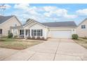 Charming one-story home with attached garage, tidy landscaping, and inviting front porch at 8714 Summer Serenade Dr, Huntersville, NC 28078