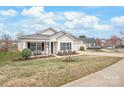 View of a well-maintained one-story home with neat landscaping and a cozy front porch at 8714 Summer Serenade Dr, Huntersville, NC 28078