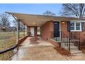 Cozy brick home featuring a covered carport, black shutters, and a freshly painted front door at 901 Wyke Rd, Shelby, NC 28150