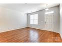 Spacious living room featuring hardwood floors and neutral walls at 104 N Canyon Ridge Dr, Mount Holly, NC 28120