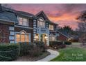 Elegant brick home showcasing a classic design, complemented by manicured shrubs and a neatly paved walkway at 10417 Sutherby Dr, Charlotte, NC 28277