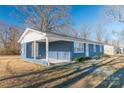 Blue ranch home with covered porch, perfect for relaxing at 1127 Ansonville Rd, Wingate, NC 28174