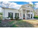 Charming white home with dark shutters and a classic portico at 1139 Hermitage Rd, Rock Hill, SC 29732