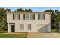 Two-story house with white siding, black shutters, and a two-car garage at 152 Oliver St, York, SC 29745