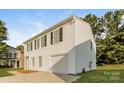 White two-story house with black shutters, a two-car garage, and a side view at 152 Oliver St, York, SC 29745