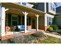 Inviting front porch with brick flooring, comfortable seating, and stylish decor at 162 Misty Woods Dr, Lake Wylie, SC 29710