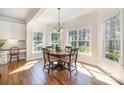 Bright dining area with hardwood floors, large windows, and elegant lighting fixture at 1806 Grayscroft Dr, Waxhaw, NC 28173