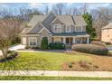 Beautiful landscaped front yard of a two-story home, showing a well-manicured lawn at 1806 Grayscroft Dr, Waxhaw, NC 28173