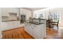 Modern kitchen with white cabinetry, stainless steel appliances, and hardwood floors at 1806 Grayscroft Dr, Waxhaw, NC 28173