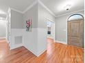 Inviting entryway featuring wood floors, wainscoting, and an arched doorway providing character and charm at 209 Chesterfield Canal None, Fort Mill, SC 29708